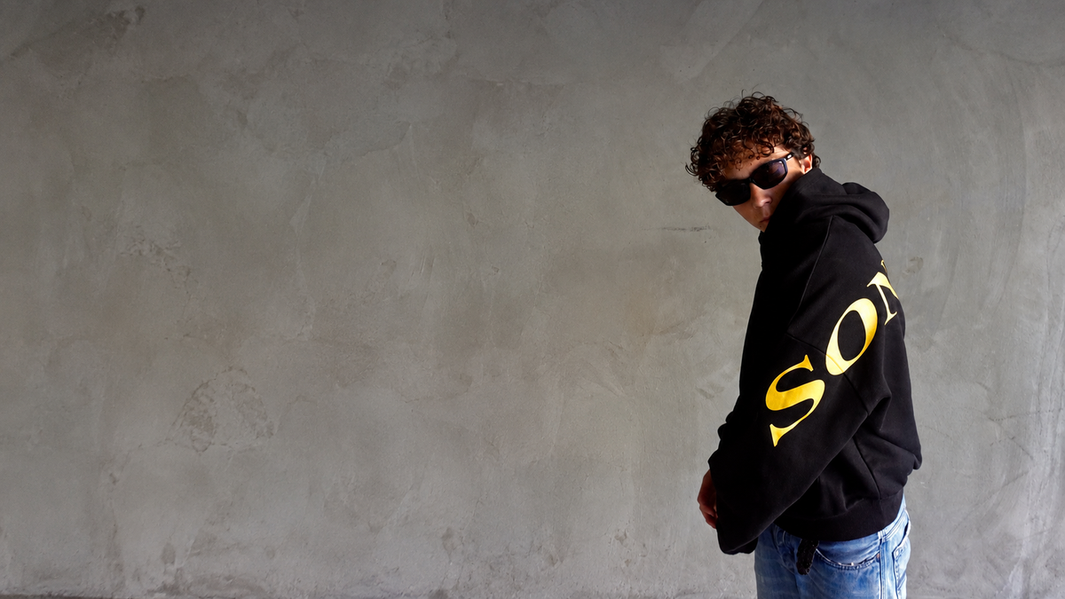 Model wearing Sonlight against a concrete wall